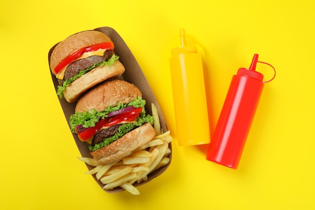 Concept of fast food on yellow background