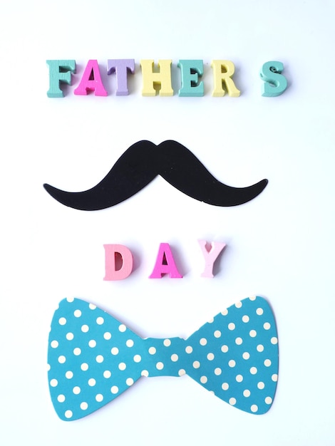 Concept of fathers day A mustache and a bow tie and the words fathers day Greeting card