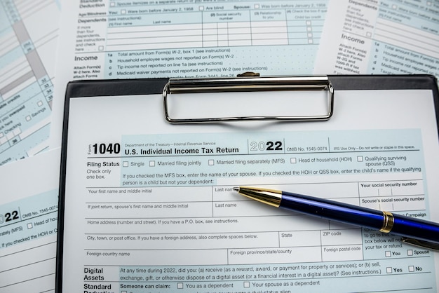 Concept of filling in 1040 tax return form with pen