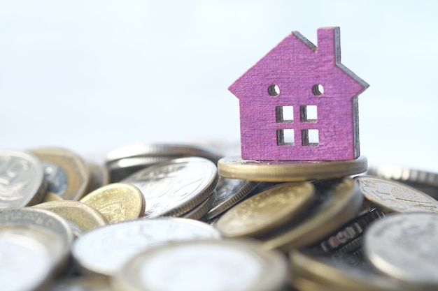 the concept of finance concept with stack of coins and house on table