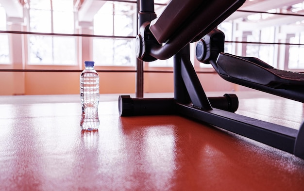 The concept of fitness with a bottle of water in the gym