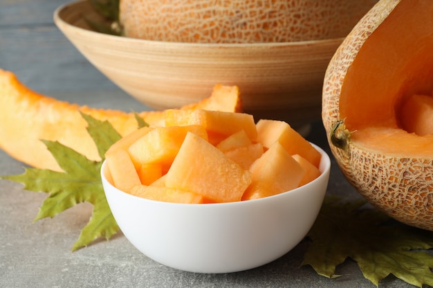 Concept of fresh food with melon on gray textured table