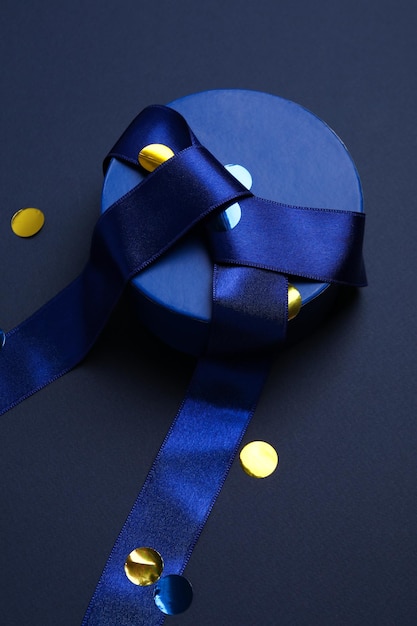 Concept of gift gift box on dark blue background