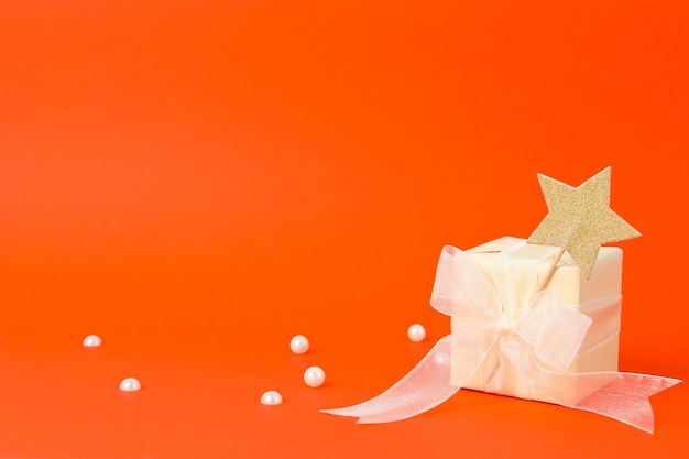 Concept of gift gift box on orange background