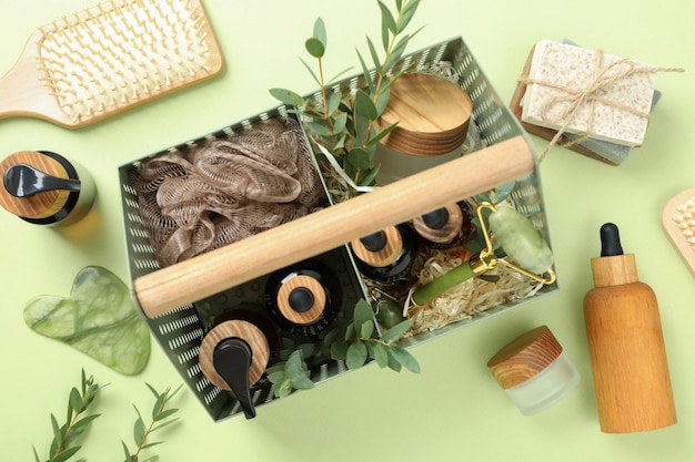 Photo concept of gift with basket of cosmetics on green background