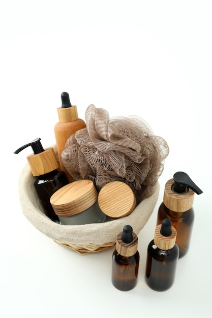 Concept of gift with basket of cosmetics on white background