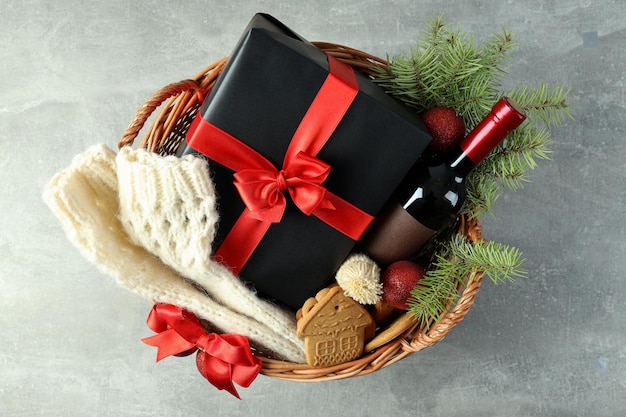 Concept of gift with Christmas basket on gray textured background