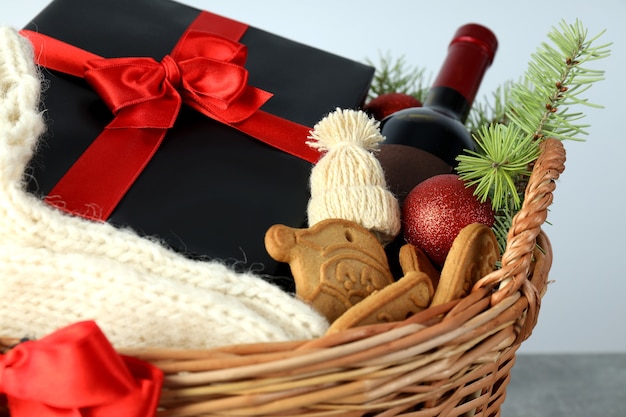 Photo concept of gift with christmas basket on gray textured  table