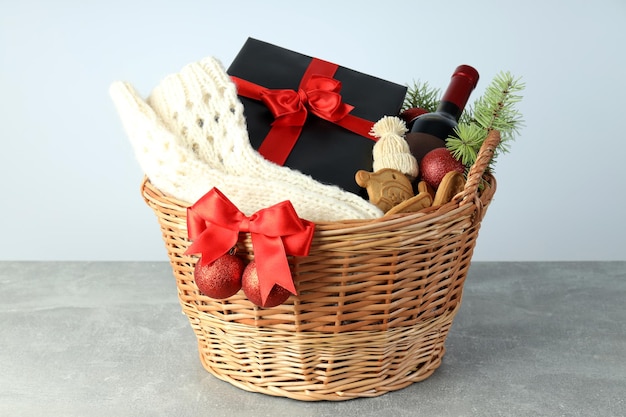 Photo concept of gift with christmas basket on gray textured  table