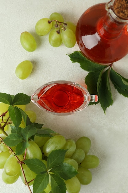 Concept of grape vinegar on white textured table