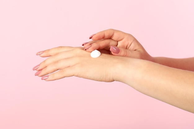 Concept of hand care on pink background