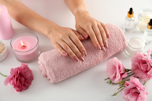 Concept of hand care with cosmetics on white background