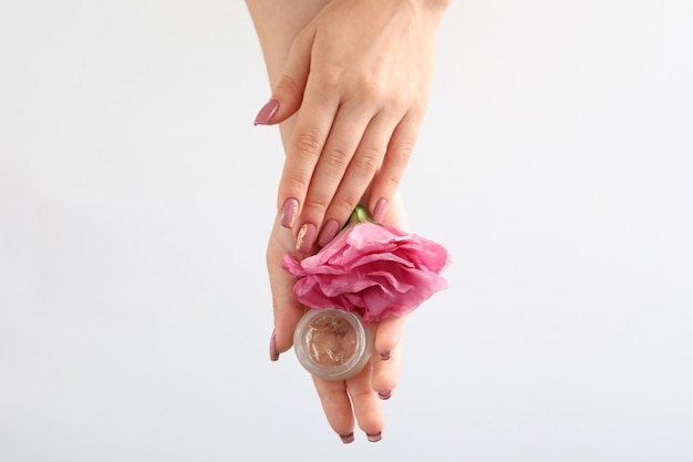 Concept of hand care with cosmetics on white background