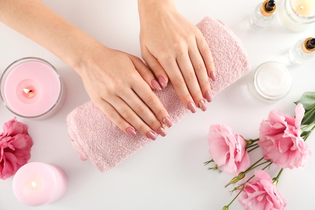 Concept of hand care with cosmetics on white background