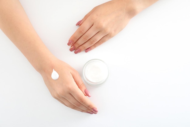 Concept of hand care with cosmetics on white background