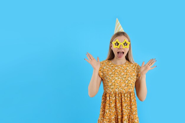 Concept of Happy Birthday with attractive girl on blue background