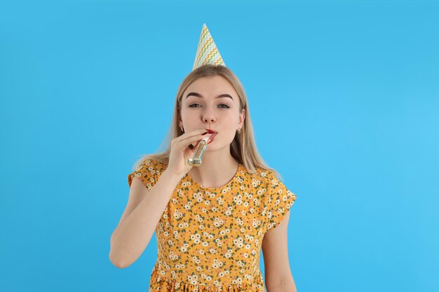 Concept of happy birthday with attractive girl on blue\
background