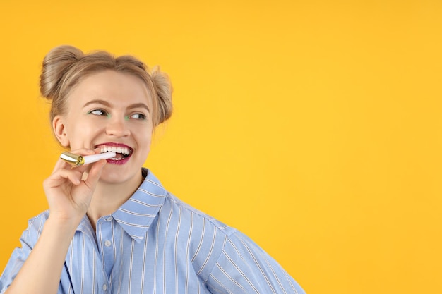 Concept of Happy Birthday young woman on yellow background