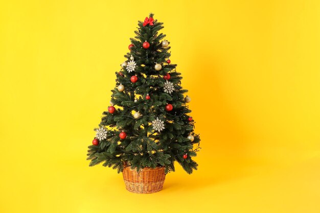 Concept of Happy New Year Christmas tree on yellow background