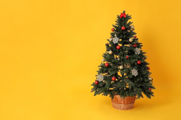 Concept of Happy New Year Christmas tree on yellow background