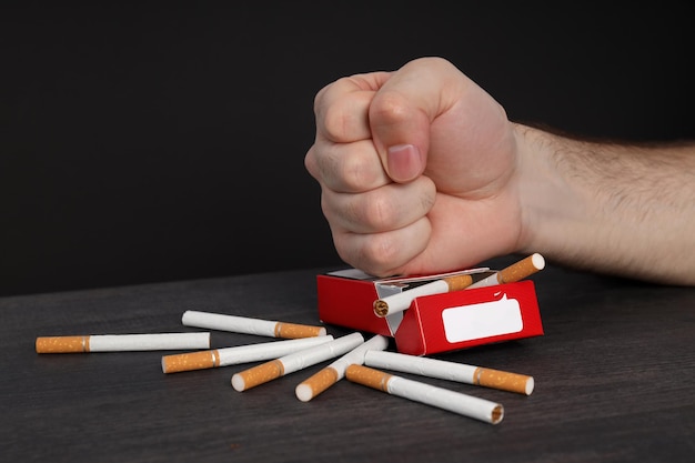 Concept of harm of smoking male hand and pack of cigarettes