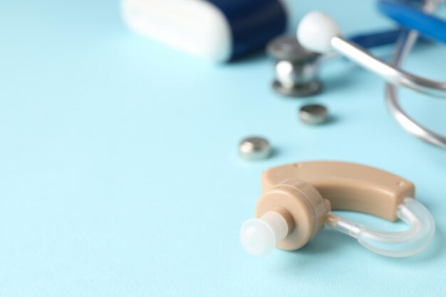 Premium Photo | Concept of health care with hearing aid on blue background