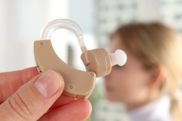 Concept of health care with hearing aid, close up