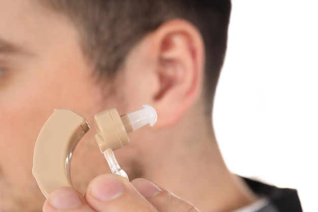 Concept of health care with hearing aid, close up