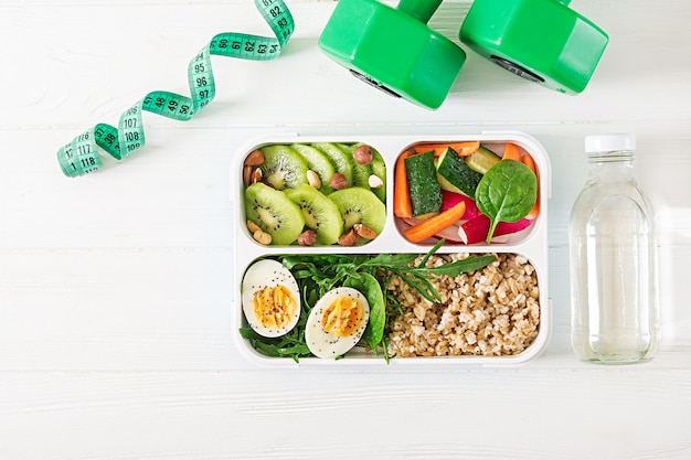 Concept healthy food and sports lifestyle. Vegetarian lunch.  Healthy breakfast. Proper nutrition. Lunchbox. Top view. Flat lay.