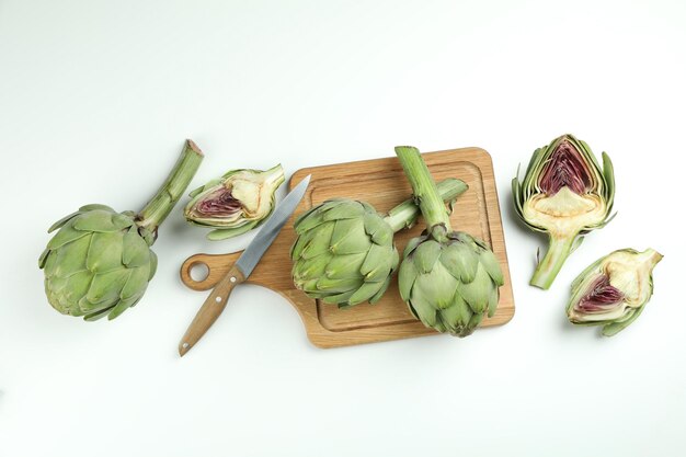 Concept of healthy food with artichoke on white background