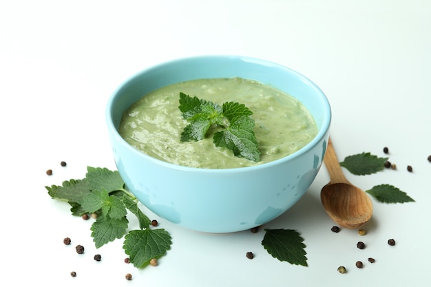 Concept of healthy food with nettle soup on white background