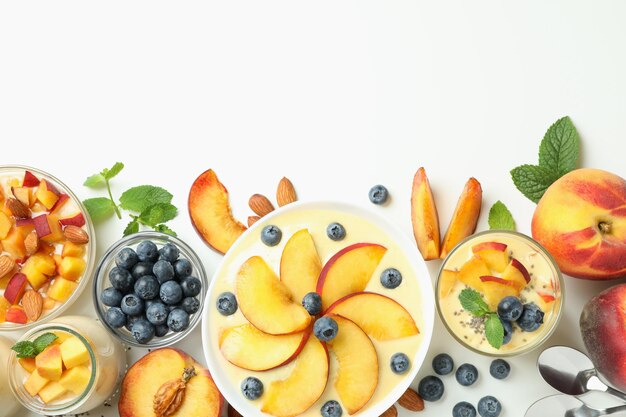 Концепция здорового питания с персиковым йогуртом и ингредиентами на белом фоне