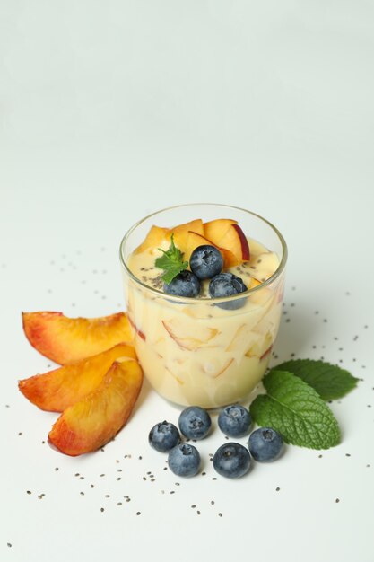 Concept of healthy food with peach yogurt on white background