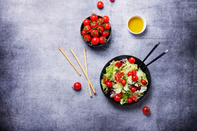 Concept of healthy vegan food. Salad with cucumber, tomato, green salad and chicory