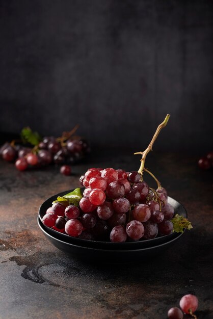 Concept of healthy vegn food Red grapes on the black table