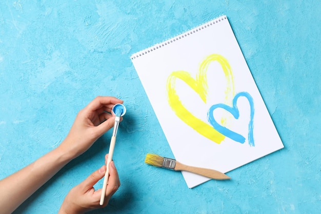 Концепция помощи Украине рисунок двух желтых и синих сердец