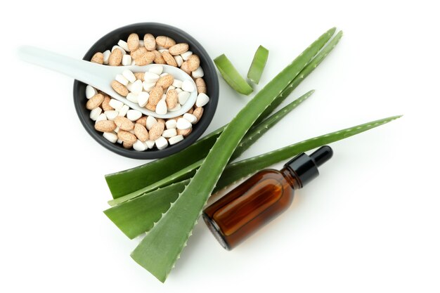 Concept of herb pills with aloe isolated on white background