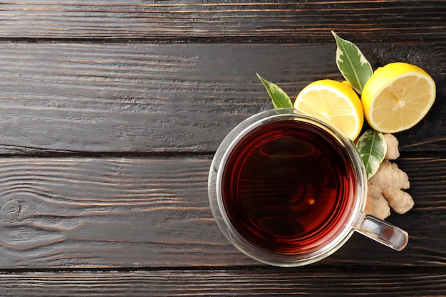 Concept of hot drink with tea on dark wooden background