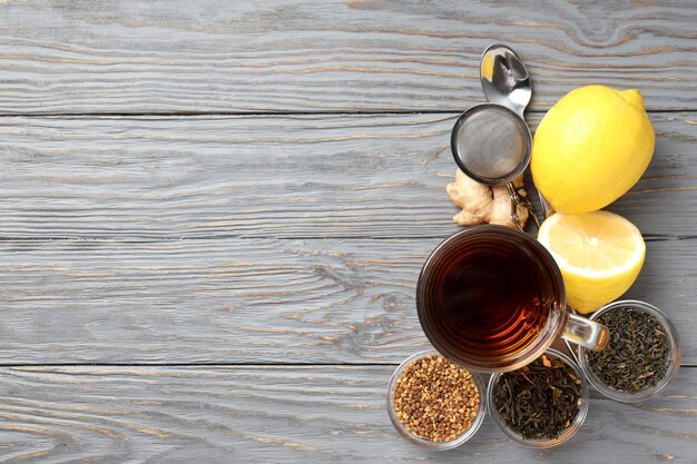 Concept of hot drink with tea on gray wooden background