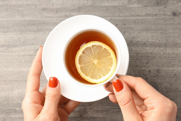 Concept of hot drink with tea on gray wooden background