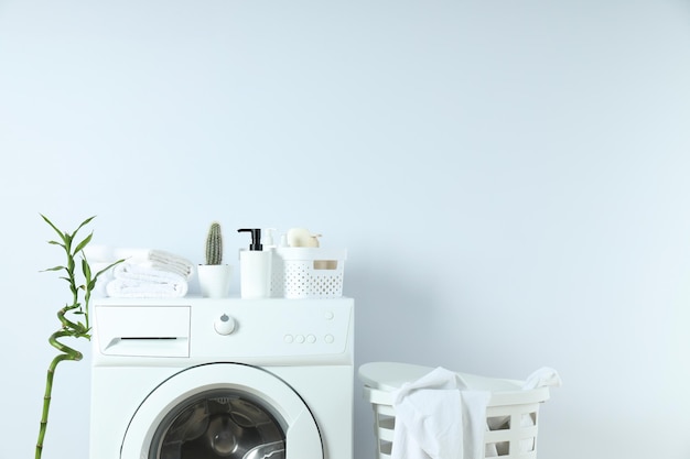 Concept of housework with washing machine on white background