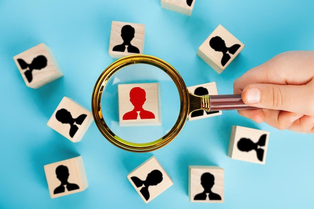 Photo the concept of human resource management and recruitment. magnifying glass looking for a person's badge, building a strong team, the concept of human resource management and management