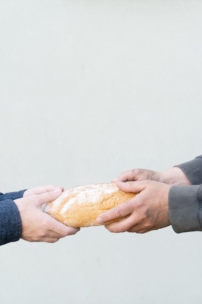 Photo concept of a hunger one man giving another bread