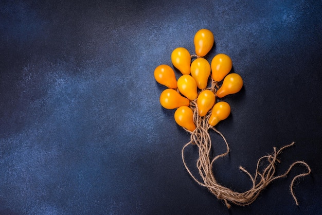 The concept idea in the form of balloons on ropes is made of yellow tomatoes