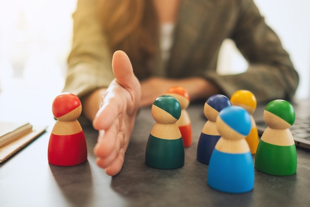 Concept image of a business woman separate one wooden people from a group