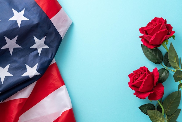 Concept of Independence day or Memorial day American Flag over blue table background with red rose