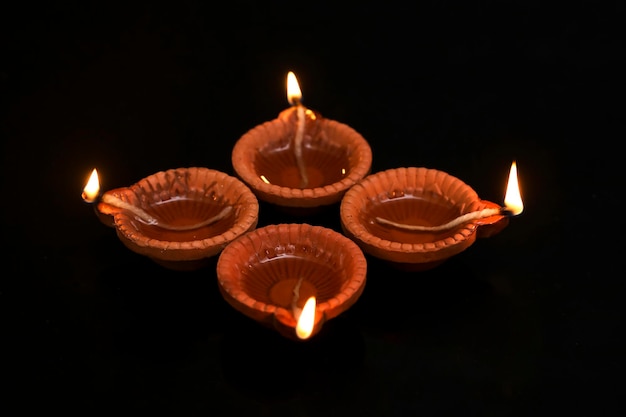 Concept of indian festival diwali Traditional oil lamps on dark background