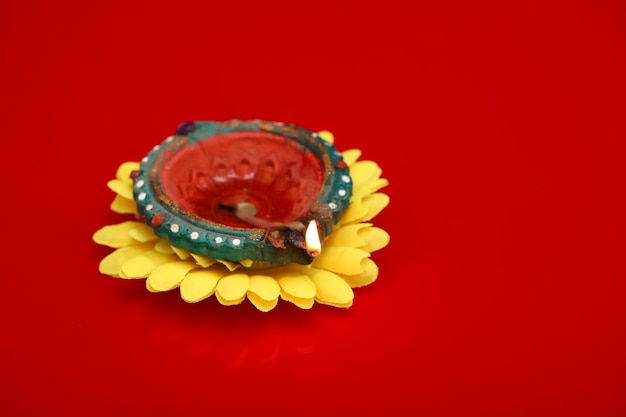 Concept of indian festival diwali Traditional oil lamps on Red background