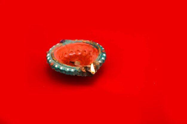 Concept of indian festival diwali Traditional oil lamps on Red background