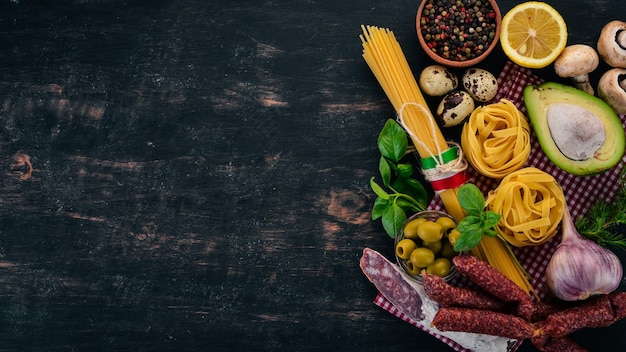 Concept of Italian cuisine Pasta Basil and Vegetables On a wooden background Top view Copy space